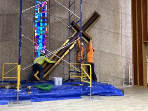 Construction workers putting the cross up on the new sanctruary